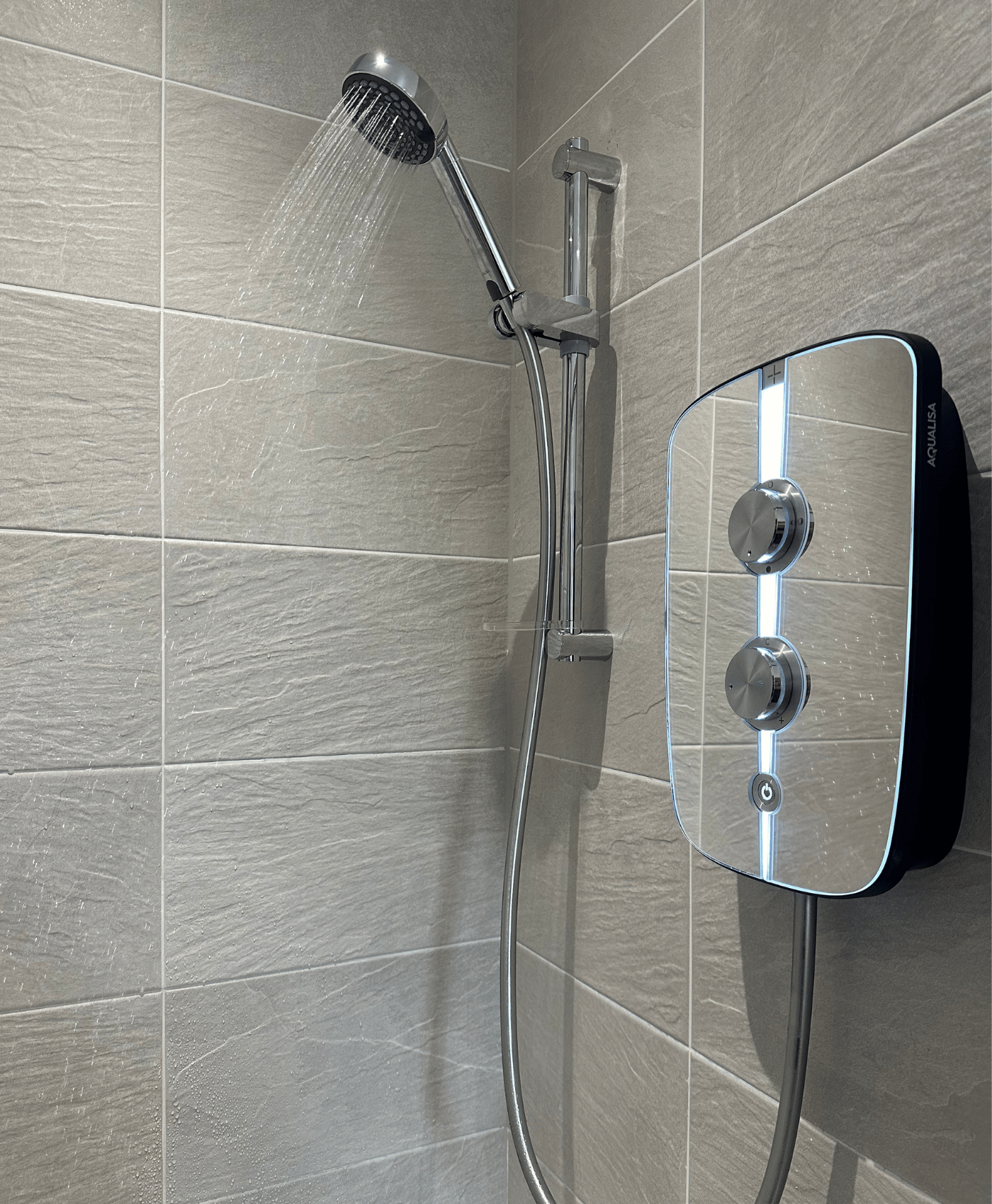Replacement electric shower installed on a tiled bathroom wall in Taunton.