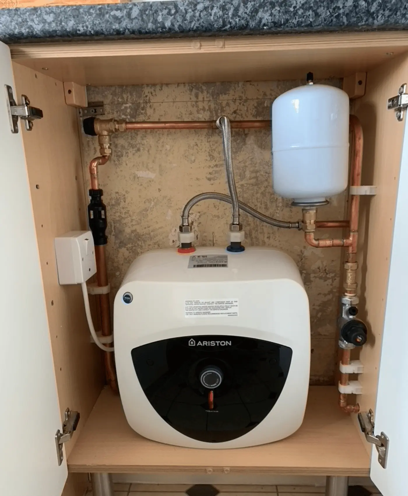 Electric water heater and pipework installation in cupboard by plumb inc plumbing services of taunton.