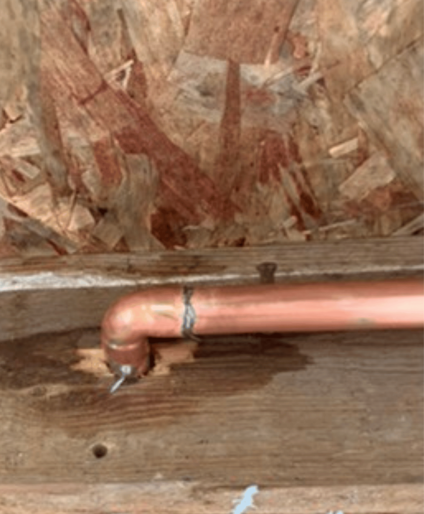 Copper pipework with a leaking joint exposed beneath the floor during a plumbing repair in Taunton.